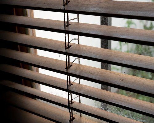 Modern blinds filtering intense sunlight in a cozy living room